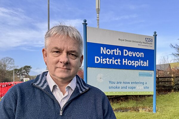phil in front of NDDH sign